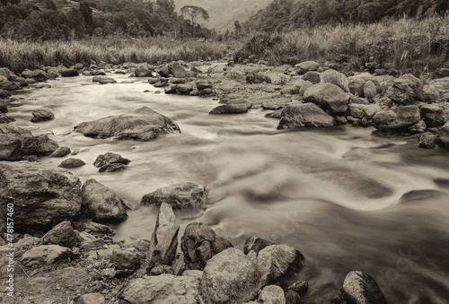 Beautiful Reshi River water flowing through stones and rocks, Sikkim, India. Reshi is famou river of Sikkim flowing through the state and serving water to many local people. Sepia toned image. photo