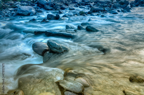 Beautiful Reshi River water flowing through stones and rocks at dawn, Sikkim, India. Reshi is one of the most famous rivers of Sikkim flowing through the state and serving water to many local people.
