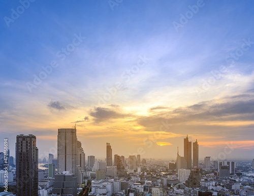 Cityscape of modern buildings and urban architecture. Aerial view of Bangkok city at twilight sunset in Thailand.