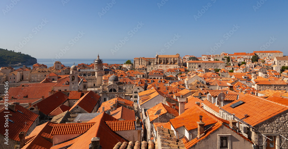 The city of Dubrovnik with its red roofed buildings and the blue sea in the background