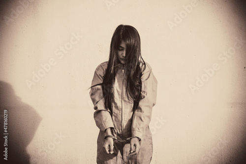 Leinwand Poster Prisoner in orange robe concept,Portrait of asian woman in Prison uniforms on wh