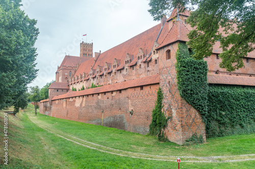 Moat with defence wall of Malbork castle at cloudy day. photo