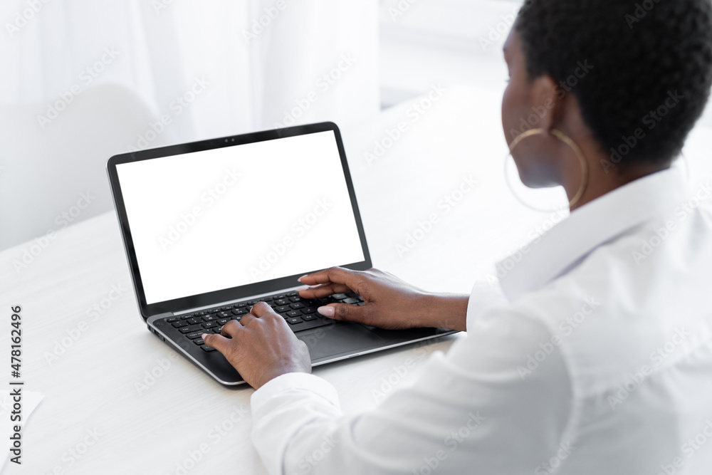 Office manager. Work from home. Distance job. Modern technology. Woman employee working at desk on laptop mockup blank screen in light workspace. Office manager. Work from home. Distance job. Modern technology. Woman employee working at desk on laptop mockup blank screen in light workspace.
