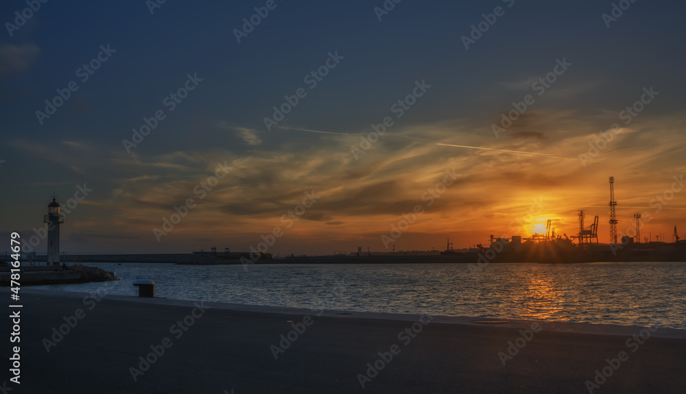 Calm sea with sunset sky and sun through the clouds over. Meditation ocean and sky background. Tranquil seascape. Colorful horizon over the water.