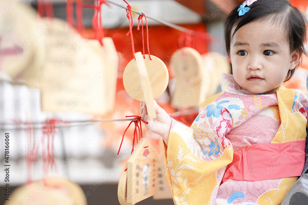 Asian cute little girl in Japanese traditional costume looking and