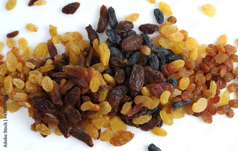 A bunch of raisins of various varieties on a white background. A bunch of raisins of various varieties on a white background.