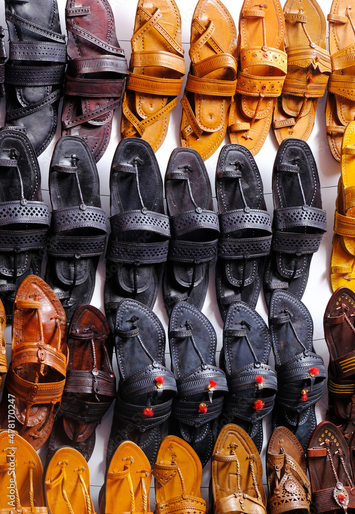 Colorful Handmade chappals being sold in an Indian market, Handmade leather slippers, Traditional footwear. Stock Photo | Adobe Stock