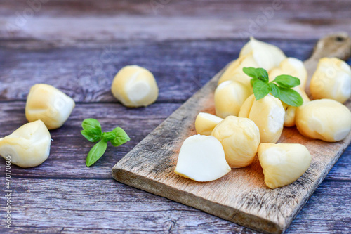  Smoked mini traditional italian provola cheese on wooden background