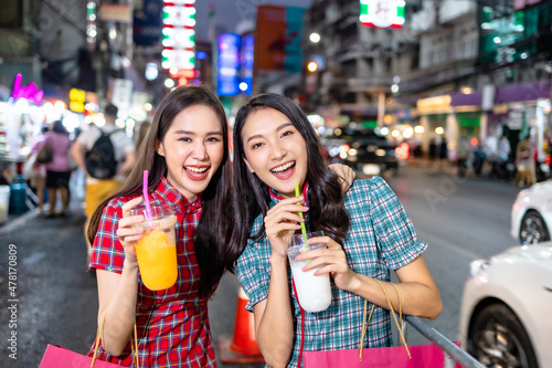 Asian woman in cheongsam dress with shopping bag. happy smiling woman holding colorful shopping bag in  china town.People traveling in city lifestyle at outdoor at China town street food market.