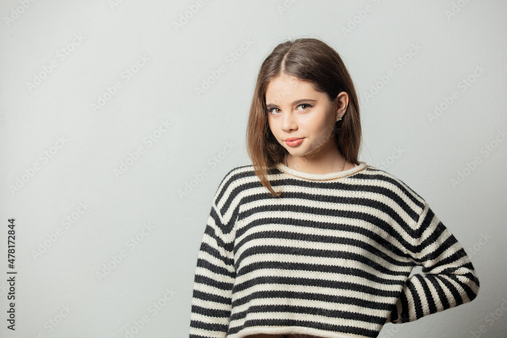 Beautiful girl in striped sweater on white background Beautiful girl in striped sweater on white background