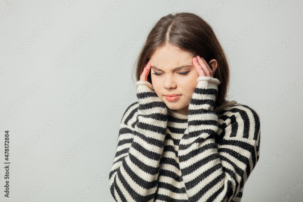 Beautiful girl in striped sweater on white background