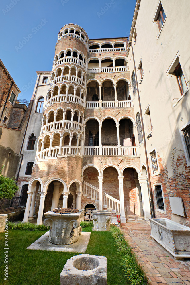 Palace Contarini del Bovolo with unusial tower with spiral arches. Beautiful spiral staircase with arched windows in Venice, Italy.