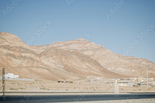 Deserted light mountains and blue sky. Landscape by the road. Jordan