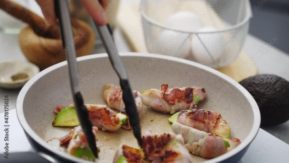 Crop unrecognizable person preparing fried avocado and bacon in kitchen Crop unrecognizable person preparing fried avocado and bacon in kitchen