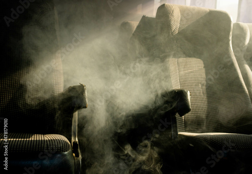 Obraz na plátně Interior of a bus with thick smoke running through the seats and spaces with direct light from the windows