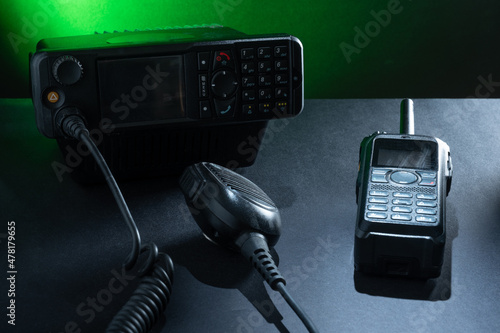 Closeup of pair of mobile two-way radios for Amateur radio operators against dark background. photo