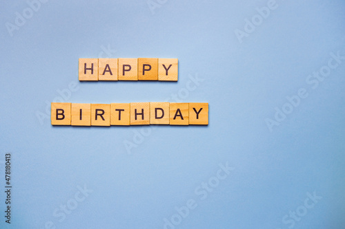 Happy birthday party, blue background with wooden text happy birthday. Ready postcard. Place for an inscription.