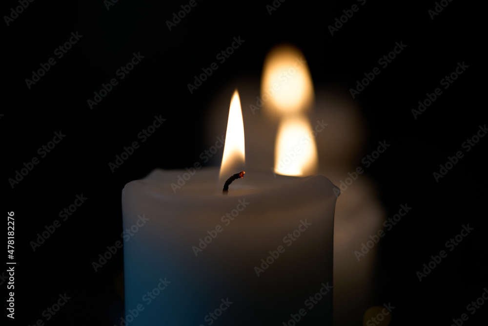 Three burning candles isolated on black background. High quality photo. Three burning candles isolated on black background. High quality photo.