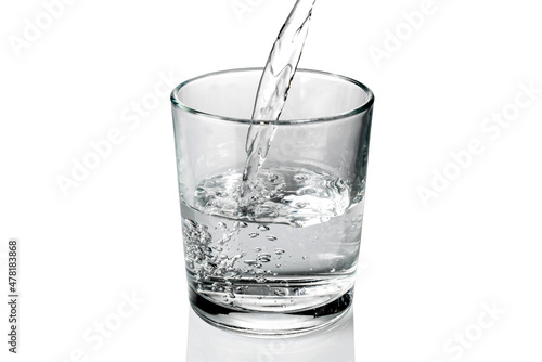 fresh water pouring into the glass isolated on white