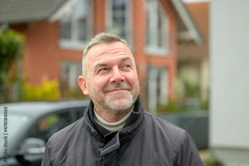 Middle-aged man looking up with an amused smile Middle-aged man looking up with an amused smile