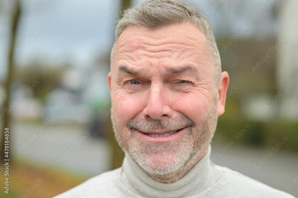 Middle-aged man winking at camera with a cheesy grin Middle-aged man winking at camera with a cheesy grin