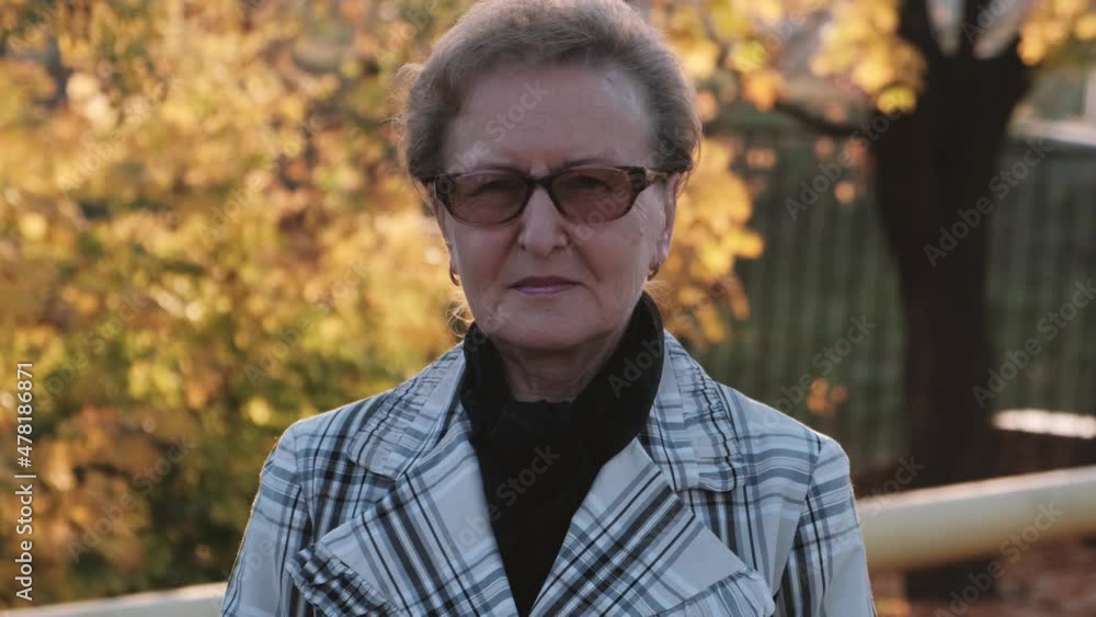 Autumn portrait of an elderly woman wearing glasses Autumn portrait of an elderly woman wearing glasses