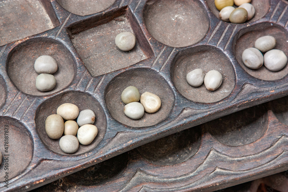 Boa Mancala tradition African Board Game With natural baobab tree seeds  Balls. Stone Town Zanzibar, Tanzania. Mancala is a game which is very  popular in Africa and Arabs Stock Photo | Adobe
