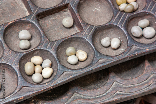 Boa Mancala tradition African Board Game With natural baobab tree seeds Balls. Stone Town Zanzibar, Tanzania. Mancala is a game which is very popular in Africa and Arabs