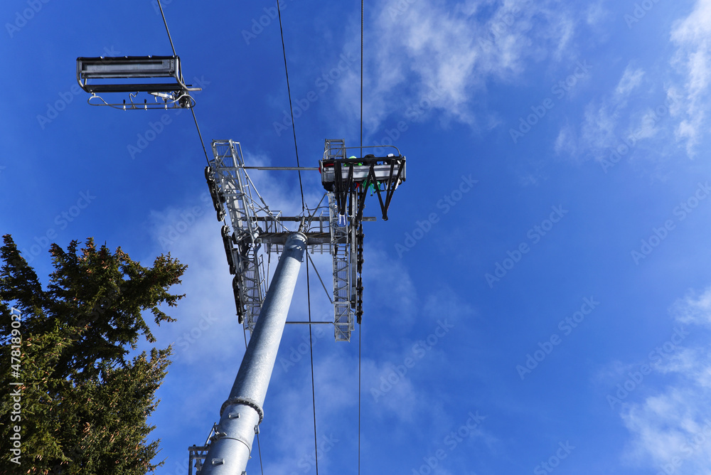 Underneath view of the chair lift with skiers the french Alps Morzine ski area. Underneath view of the chair lift with skiers the french Alps Morzine ski area.