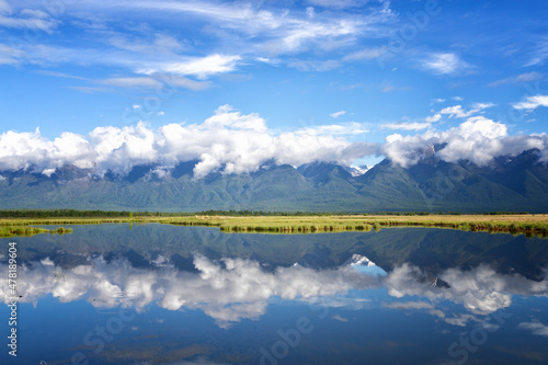 Landscape with mountains reflecting in the water on summer day. Buryatia, Tunkinskaya valley photo