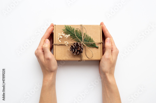 Handmade gift box in female hands. Present for Christmas