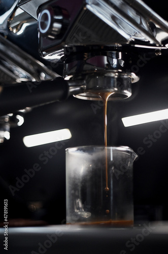 Hot espresso shot flowing from machine
