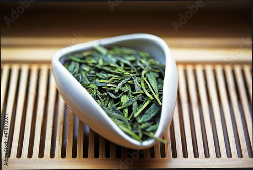 Chinese green tea Dragon Well in Tea presentation vessel, macro photo
