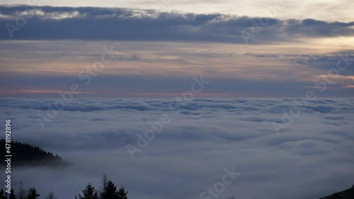 Sky time lapse form above the fast clouds at dusk in the mountains looking over the Padan Plain photo