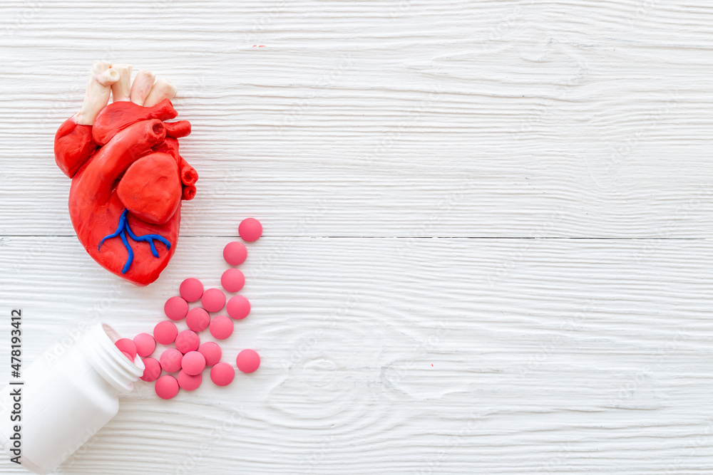 Human heart model with pills top view. Cardioigy and heart health ...