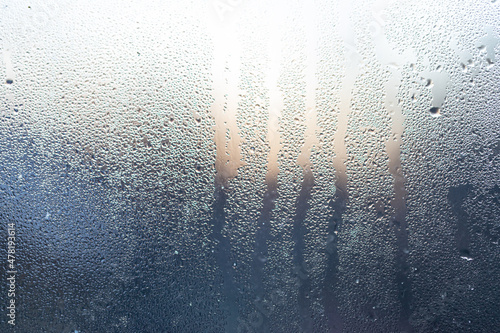 Canvas Print dew on window glass in morning light