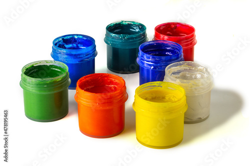 Set of gouache paint pots of different colors on isolated white background. Open paint cans for drawing. Gouache set.