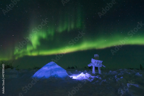 Northern Lights with an igloo and snow inukshuk in the foreground photo