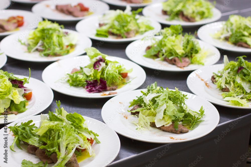 Plates with vegetable salad in a restaurant Plates with vegetable salad in a restaurant