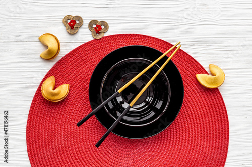Fortune cookies and golden chopsticks. Asian style tabble setting