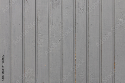 A texture of gray vertical boards with knots