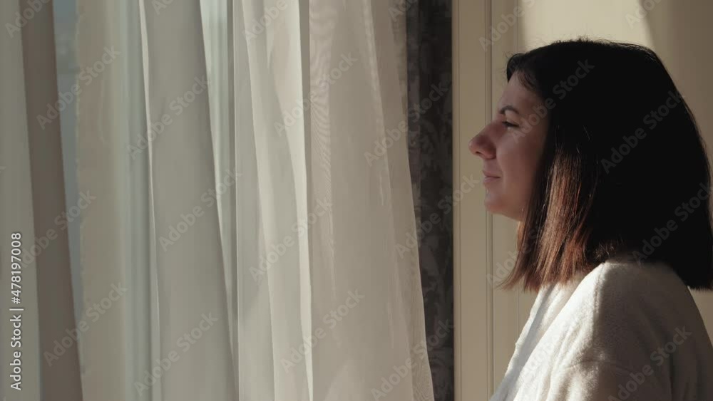 Woman Goes To Window Opens Sash And Enjoys Sunlight And Fresh Air Woman Goes To Window Opens Sash And Enjoys Sunlight And Fresh Air