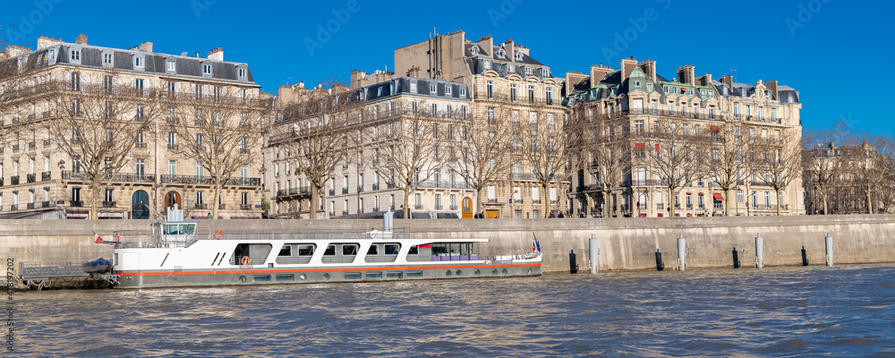 Paris, beautiful buildings avenue de New York, an upscale neighborhood on the quays, with view on the Seine and a houseboat
