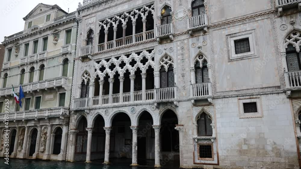 Venice, Italy - Sailing along the Grand Canal among the historic buildings of the lagoon city on a cloudy winter day Venice, Italy - Sailing along the Grand Canal among the historic buildings of the lagoon city on a cloudy winter day