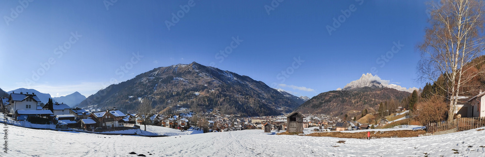 Panoramic view on village and Valle di Primiero during  sunny day and winter season