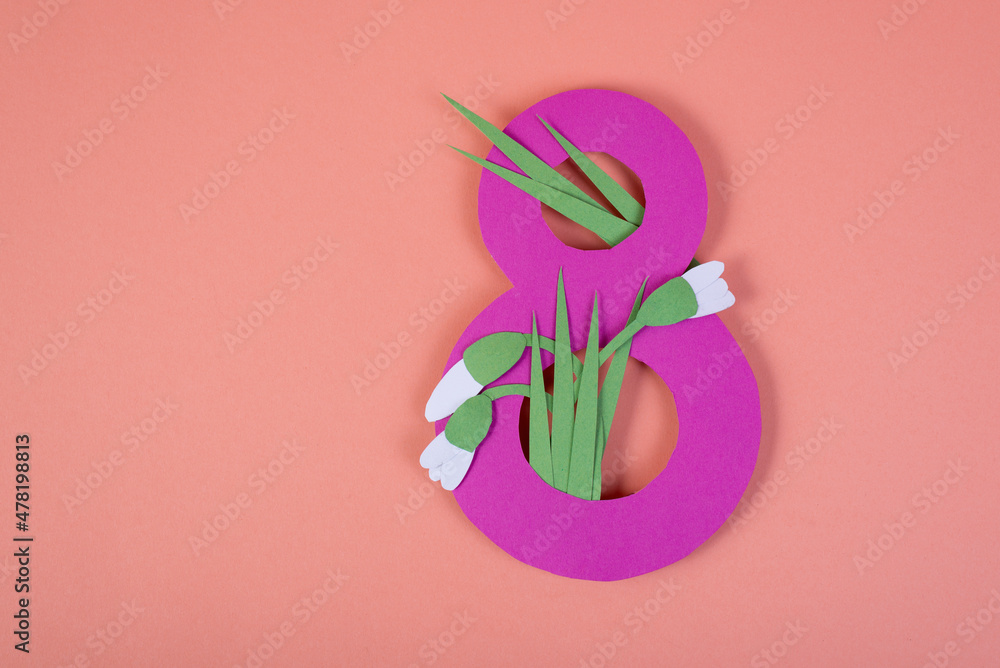 Paper art Eight number cut of pink against the pink background with paper cut snowdrops. 8 March, women's day background with empty space.