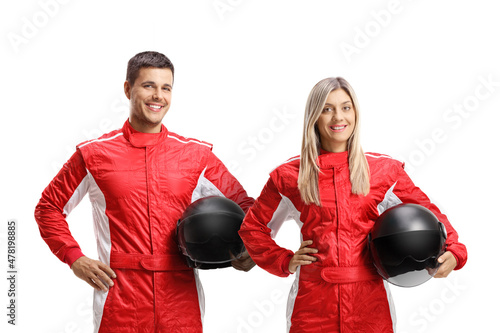 Fototapeta Male and female car racer in a red suit holding helmets