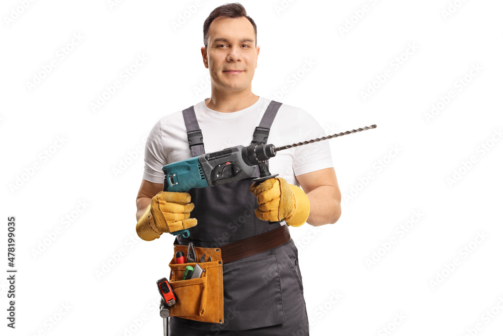 Portrait of a repairman holding a drilling machine Portrait of a repairman holding a drilling machine