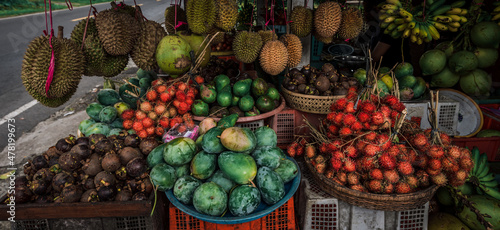 Fruit shop in Thailand. Fruit market in Indonesia Bali island. Street bazaar in Asia. Sale of fresh fruits and vegetables at the market in Thailand. A small grocery store on the street of Bali island