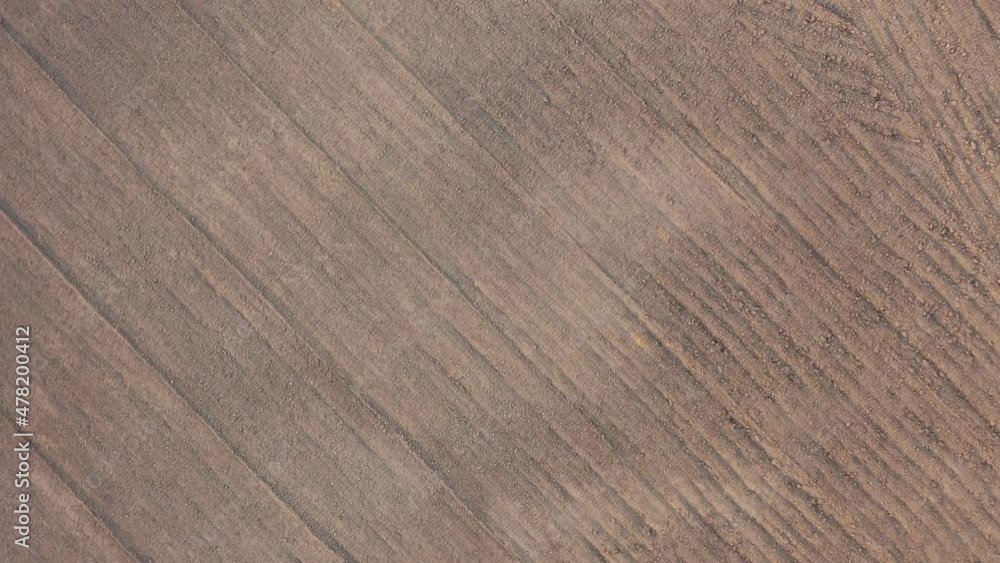 Top down view of empty plowed farm field zoom twist to ground Top down view of empty plowed farm field zoom twist to ground